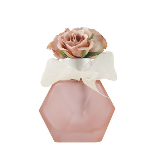 Bottiglia per profumo colore rosa e rose rosa